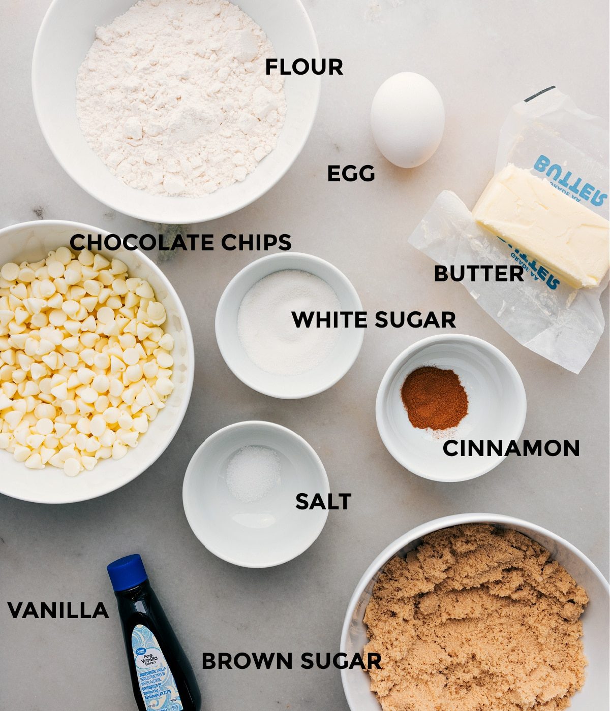 All the ingredients in the recipe including chocolate chips, egg, sugar, cinnamon, salt, butter, and flour, prepped out for straightforward assembly of this recipe.