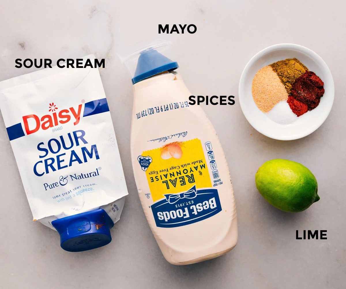Dressing ingredients prepped for straightforward assembly in this Southwest Chicken Salad recipe: sour cream, mayo, spices, and lime.