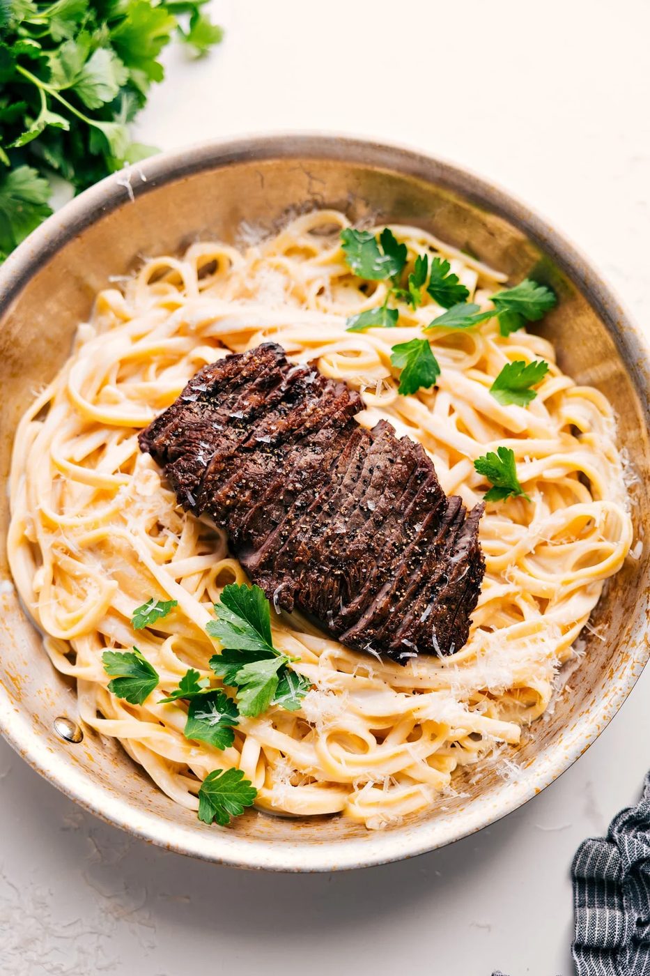Steak Alfredo Recipe in the pot topped with fresh parsley, ready to be served.