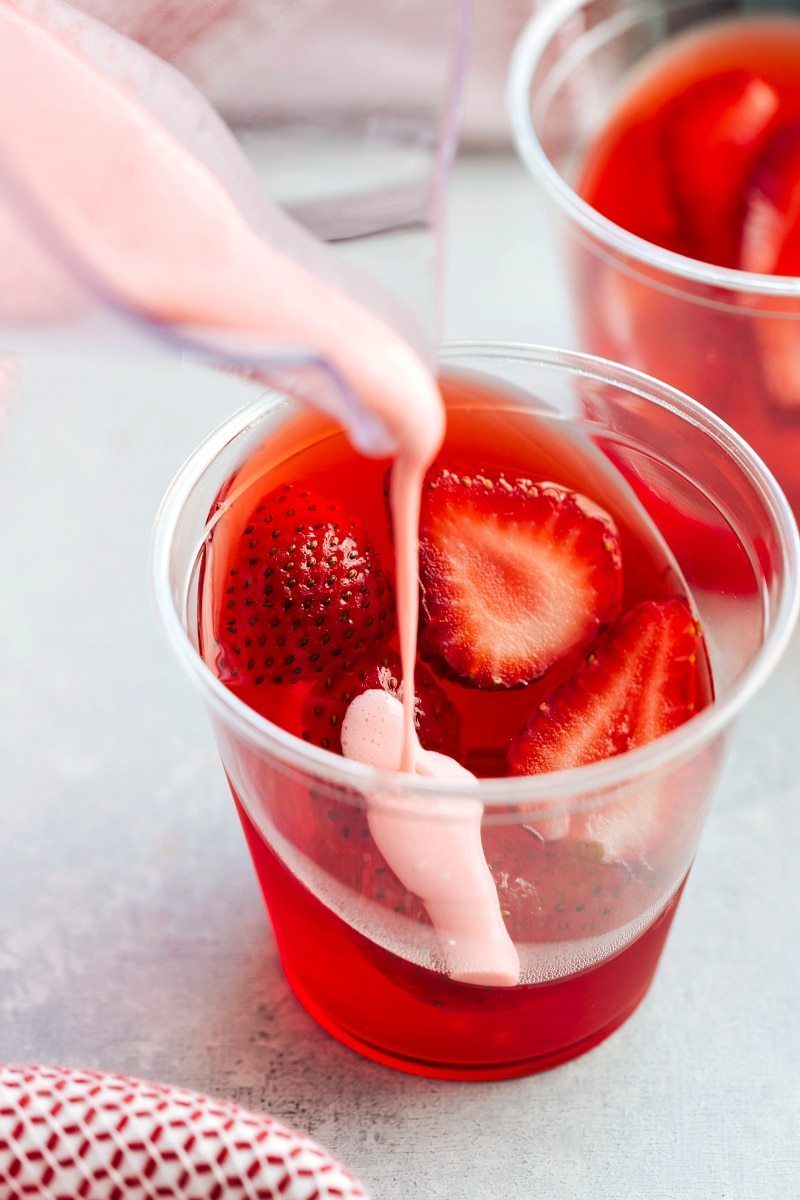 The coolest and EASIEST hack to make these slanted jell-o parfait cups with a strawberry mousse on top. satisfying and so straightforward!! Recipe from flexfa.com