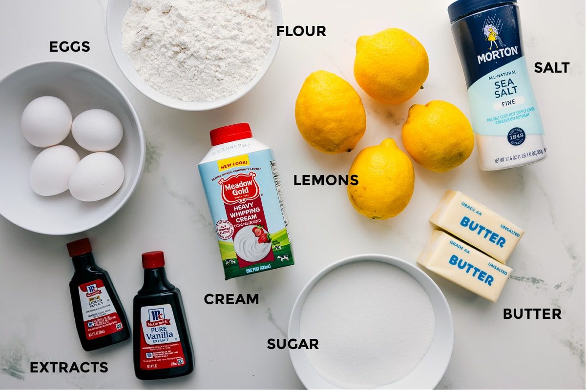 All the ingredients for lemon bars prepped and ready for straightforward assembly, including eggs, flour, salt, butter, sugar, cream, and extracts.