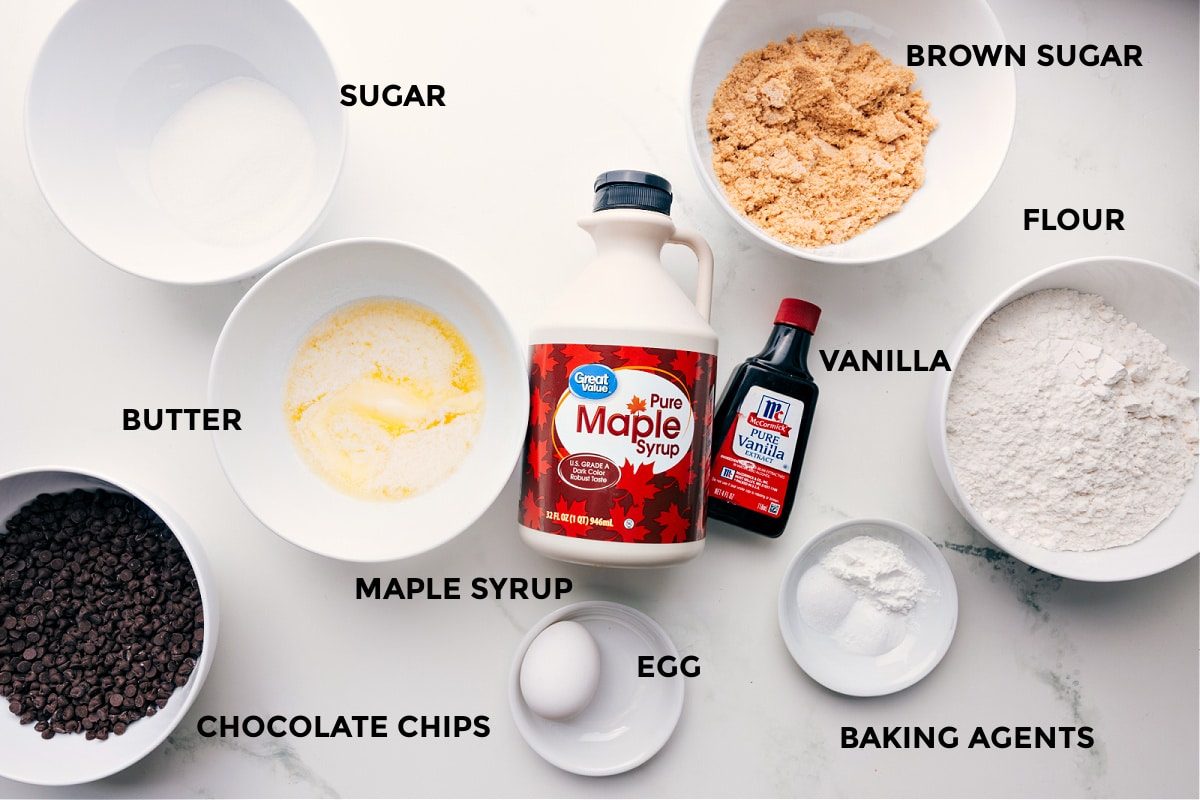 All the ingredients in this recipe prepped out for straightforward assembly including the sugar, butter, maple syrup, chocolate chips, egg, brown sugar, flour, vanilla, and baking agents.