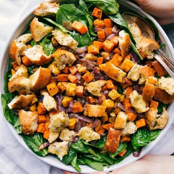 Roasted veggie salad in a giant bowl, satisfying and filling, ready to be served.