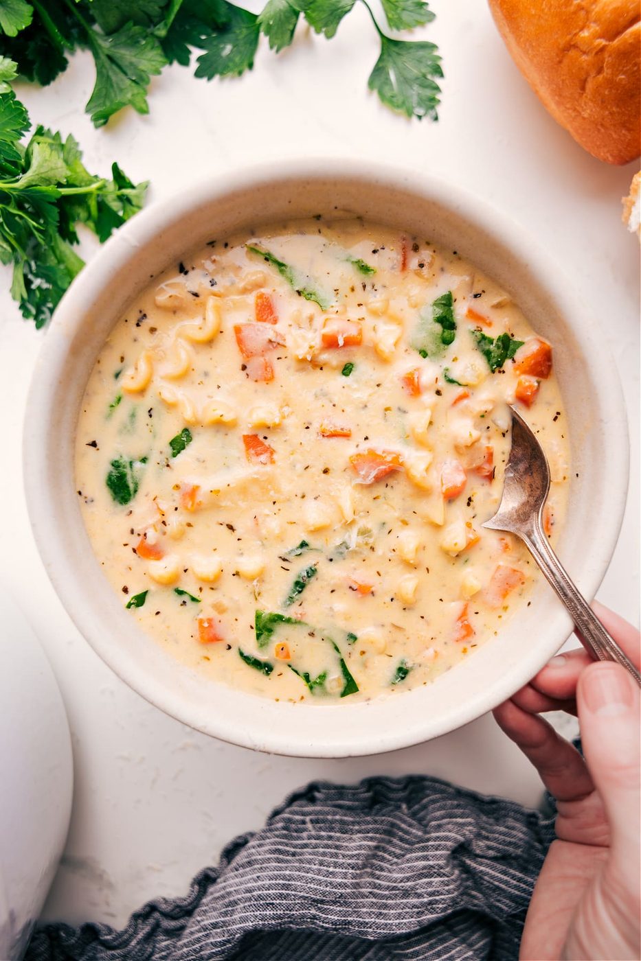 White Chicken Lasagna Soup served in a bowl, topped with cheese and herbs, ready to be enjoyed.