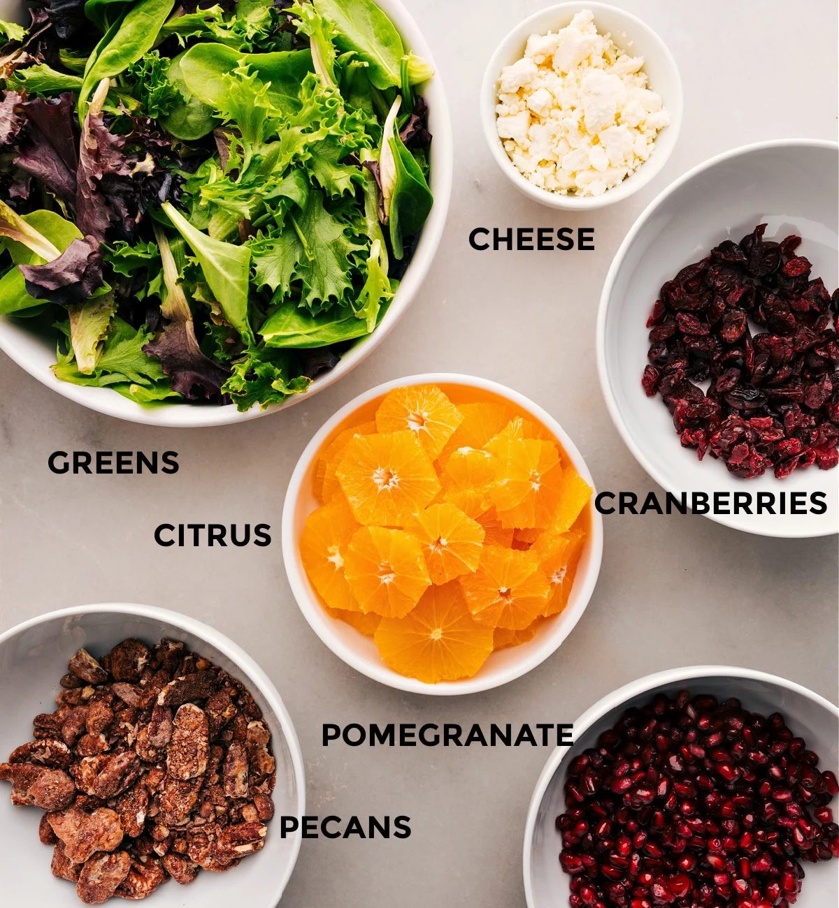 This recipe is prepped for straightforward assembly with greens, cheese, cranberries, citrus, pomegranate, and pecans.