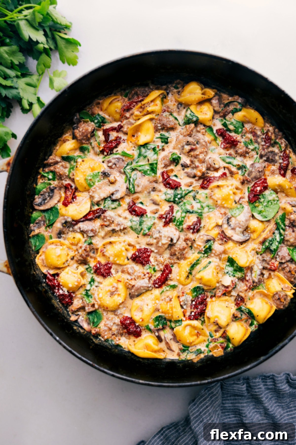 Sausage Tortellini Bake fresh out of the oven, garnished with fresh herbs, ready to be served.