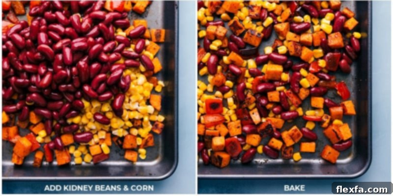Process shot showing drained kidney beans and frozen corn added to a sheet pan with roasted sweet potatoes and bell peppers, ready for a final roast.