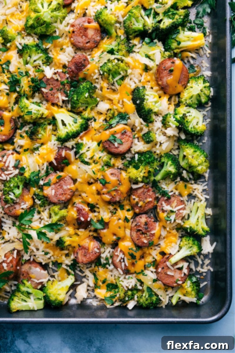 Cheesy Chicken, Broccoli, and Rice on a tray ready to be enjoyed, showcasing golden roasted vegetables and melted cheese.