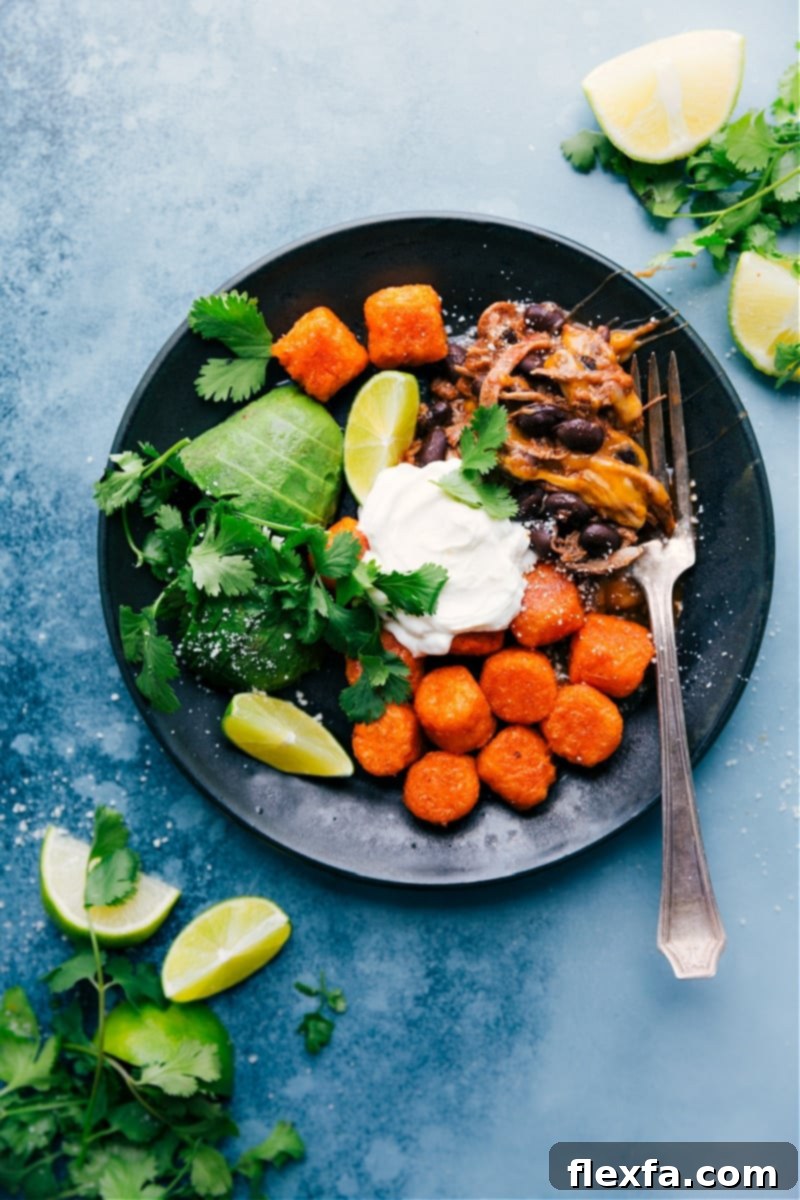 Deconstructed Beef Totchos are Tater Tot nachos dismantled into component parts: saucy beef, black beans, sweet potato tots, and favorite nacho toppings. A quick and easy one-sheet-pan meal with less than 10 ingredients. #dinner #quick #easy #simple #best #30mins #avocado #cheese #tatertots #sweetpotato #deconstructed #beef #totchos Deconstructed Beef Totchos - a sheet pan meal with saucy beef, black beans, sweet potato tots, and toppings