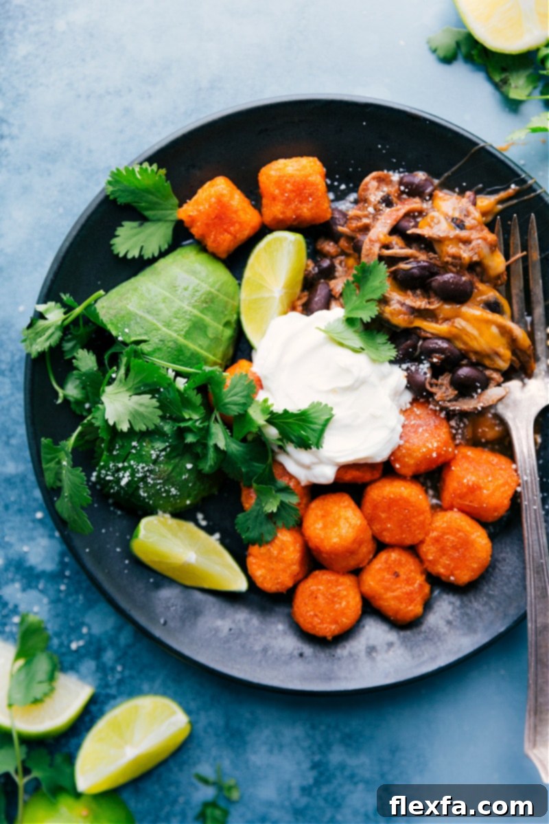 This Deconstructed Beef Totchos meal is made on one sheet pan with less than 10 ingredients, perfect for a quick dinner. Recipe via ChelseasMessyApron #dinner #quick #easy #simple #best #30mins #avocado #cheese #tatertots #sweetpotato #deconstructed #beef #totchos Deconstructed Beef Totchos served with toppings