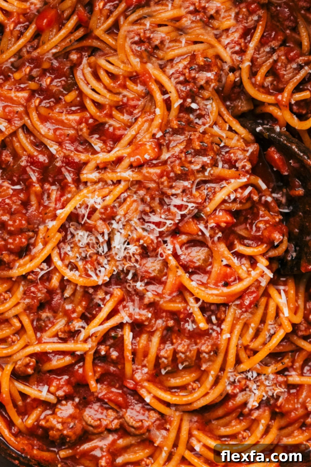 The finished One Pot Spaghetti dish, ready to be served, topped with fresh herbs.