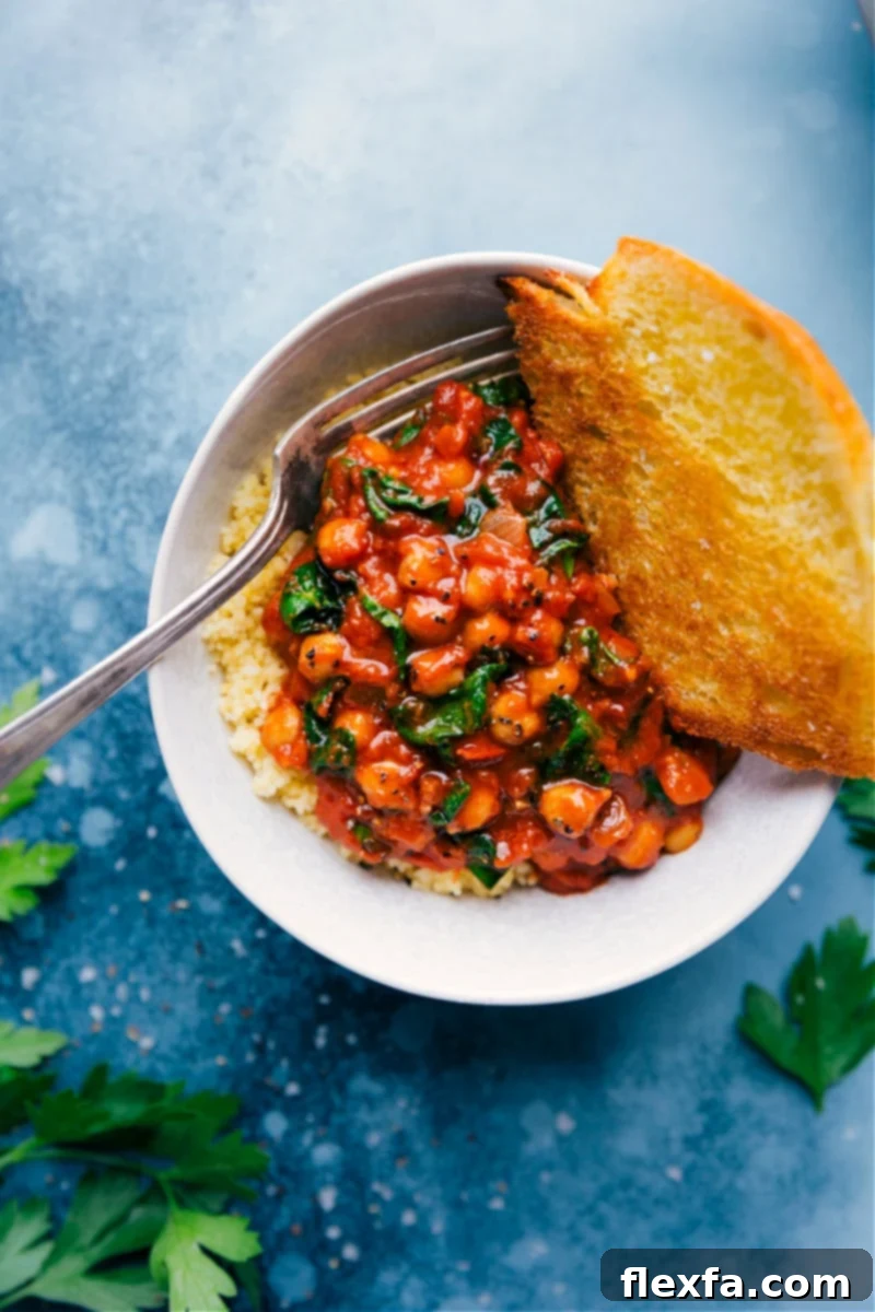 Delicious Chickpea Beans on Toast, topped with fresh herbs and cheese, served on toasted bread.