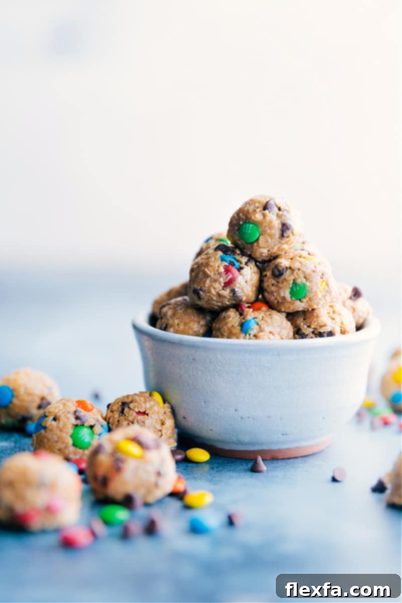 A bowl brimming with vibrant Monster Energy Bites, featuring their distinctive M&M's and chocolate chips.