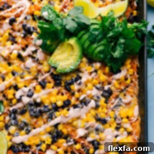 Close-up of freshly made Sweet Potato Nachos, piled high with toppings and sauce.