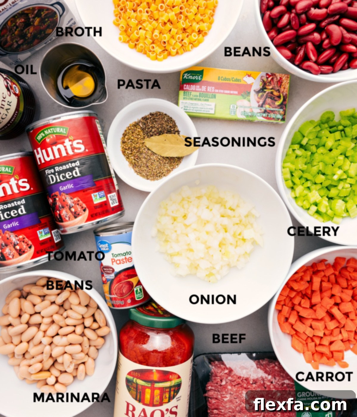 Ingredients In Pasta E Fagioli A vibrant display of fresh ingredients for Pasta e Fagioli, including finely diced carrots, celery, onion, garlic, ground beef, two types of beans, fire-roasted tomatoes, tomato paste, marinara sauce, beef broth, dried herbs, and ditalini pasta.