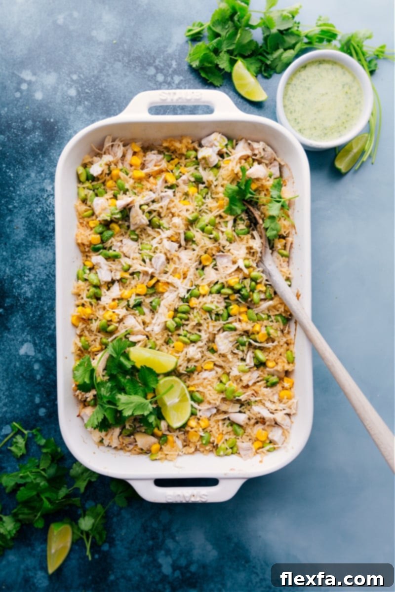 The best ever coconut chicken and rice, a truly easy, flavorful, and comforting one-pan dinner solution. Creamy Coconut Chicken and Rice served in a large casserole dish, beautifully garnished with fresh cilantro and vibrant lime wedges.