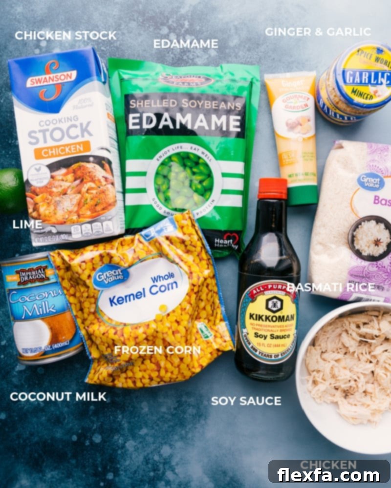 All the essential ingredients meticulously laid out for preparing this delicious and easy coconut chicken and rice meal. An organized display of fresh and frozen ingredients for making Coconut Chicken and Rice, including rich chicken stock, vibrant edamame, aromatic ginger paste, minced garlic, fresh limes, creamy full-fat coconut milk, sweet frozen corn, savory soy sauce, fragrant basmati rice, and pre-cooked rotisserie chicken pieces.