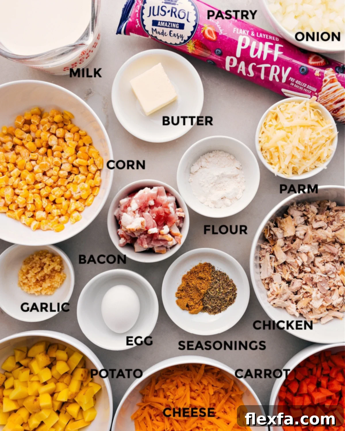 All the fresh and prepped ingredients for Corn Chowder Pot Pie, including slices of bacon, colorful diced vegetables like onions, carrots, and potatoes, cooked chicken, and blocks of cheese, laid out on a countertop for easy assembly.