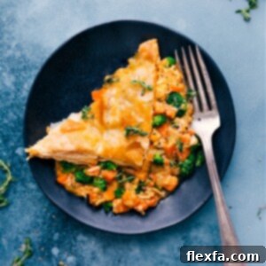 Overhead shot of a slice of Broccoli Cheddar Pot Pie with a side salad.