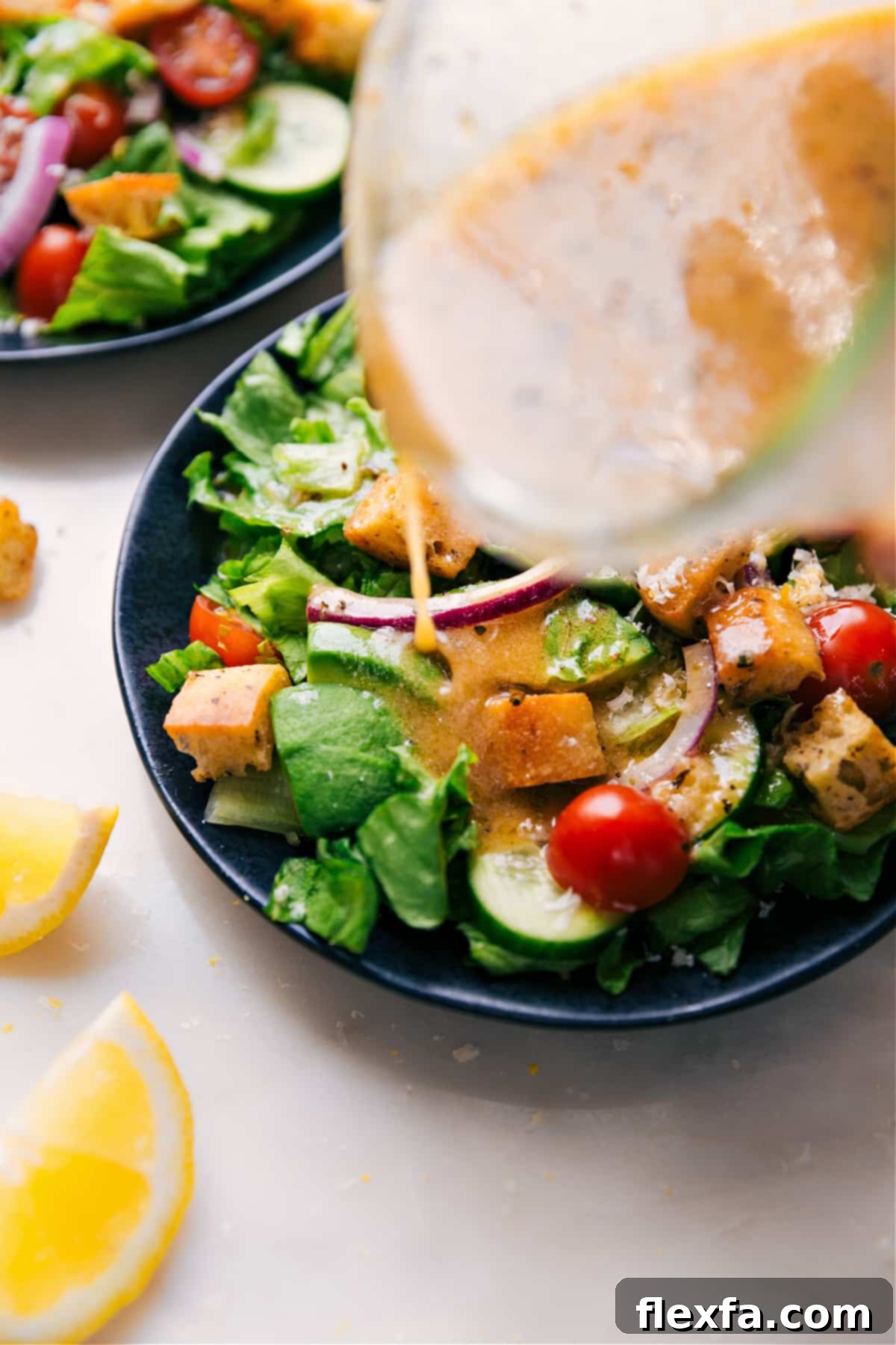 Zesty homemade Lemon Vinaigrette dressing generously poured over a vibrant, fresh garden salad.