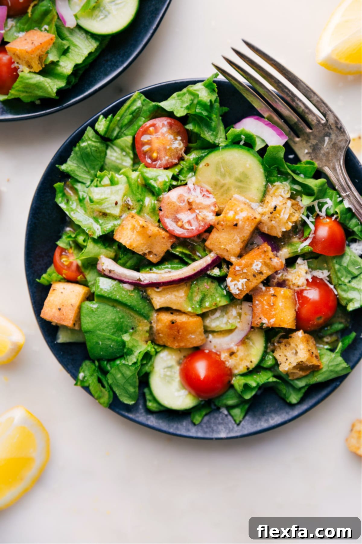 Homemade Lemon Vinaigrette being elegantly poured over a fresh, simple green salad, making it visually appealing and ready to serve.