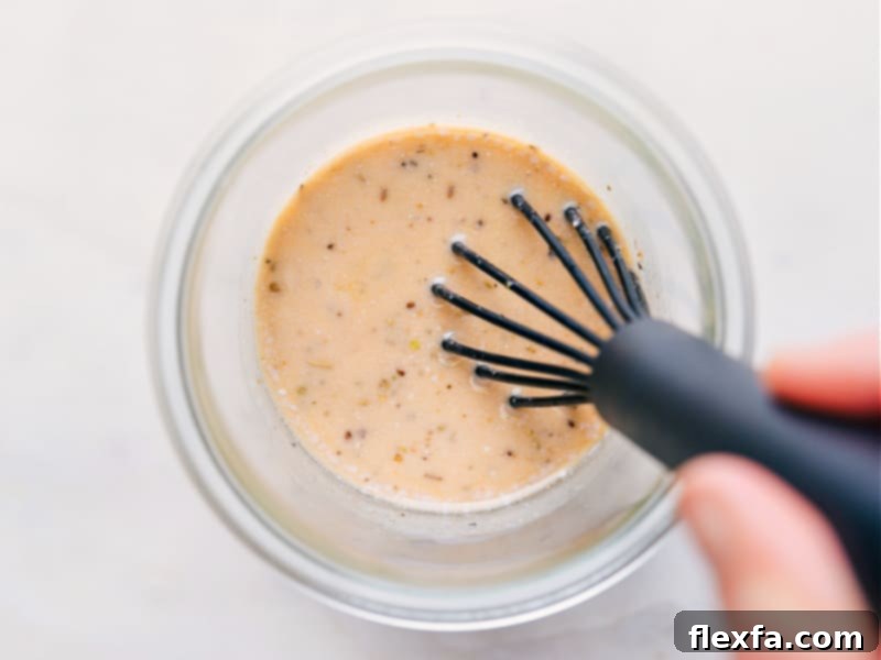 Overhead image of homemade Italian Dressing being whisked in a glass bowl