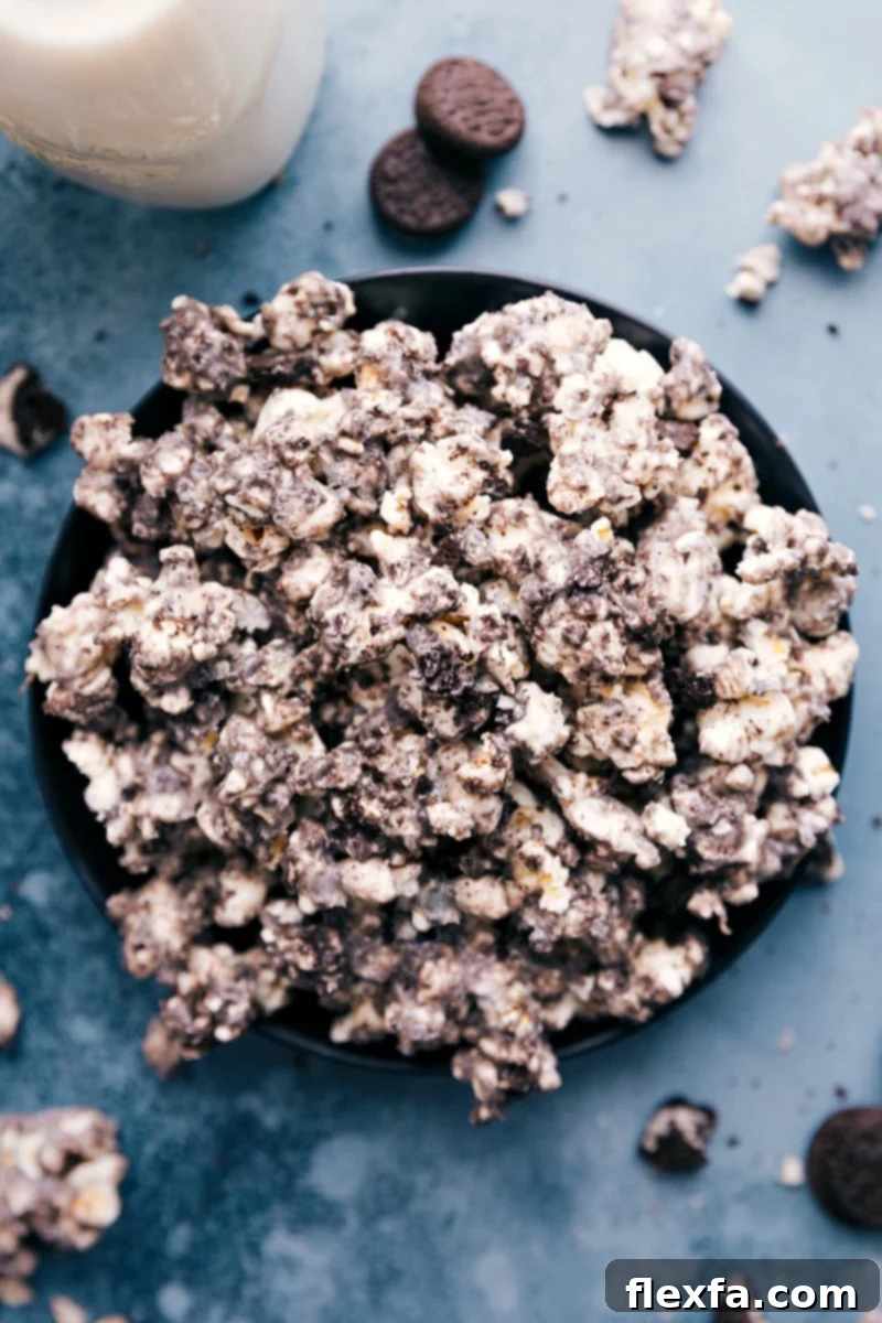 Overhead image of a large bowl of Oreo Popcorn, showcasing the white chocolate coating and crushed Oreos. Ideal for a movie night snack.