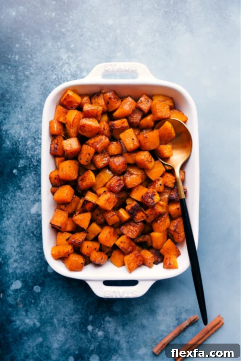 Roasted Butternut Squash is simply the best! With beautifully caramelized exteriors and tender sweet interiors, you'll be hooked after one bite! This post shares how to find the perfect squash, how to prepare it three different ways, and how to store/reheat it later! Recipe via ChelseasMessyApron #dinner #quick #easy #simple #side #best #thanksgiving #seasoned #clean #cleaneating #fresh #whole #roasted #butternut #squash Overhead image of Roasted Butternut Squash in a pan, showcasing its golden-brown caramelization