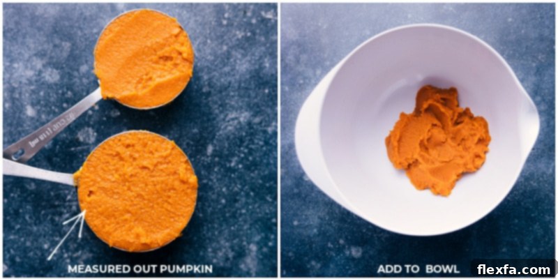 Pumpkin puree being carefully measured into a clear glass cup before being added to a large mixing bowl, highlighting precise ingredient handling.