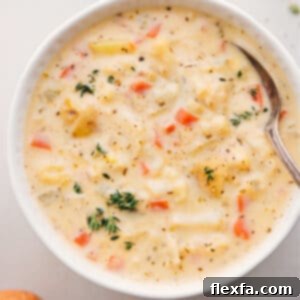 A delectable bowl of creamy cauliflower soup, generously garnished with fresh herbs and ready to be served.