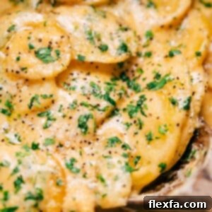 Close-up of a serving of Crockpot Au Gratin Potatoes in a bowl.
