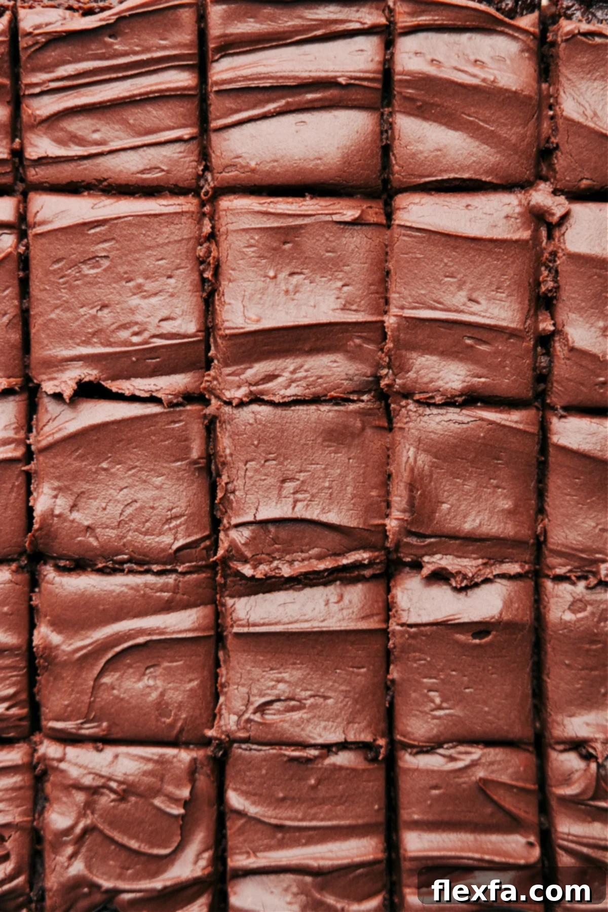 A tray of perfectly frosted and cut healthy brownies, arranged in neat squares, ready to be served as a delightful and guilt-free healthy dessert.