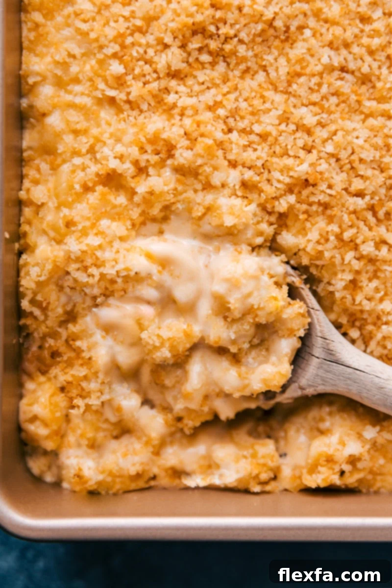 A stunning overhead shot of the best Baked Mac and Cheese, showcasing its golden-brown, crispy panko topping and hints of the rich, creamy pasta beneath. It's garnished and ready to be served, promising a delightful culinary experience.