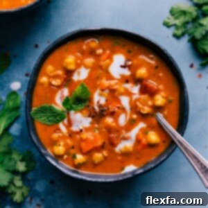 Delicious Chickpea Soup in a bowl garnished with fresh herbs and lemon.