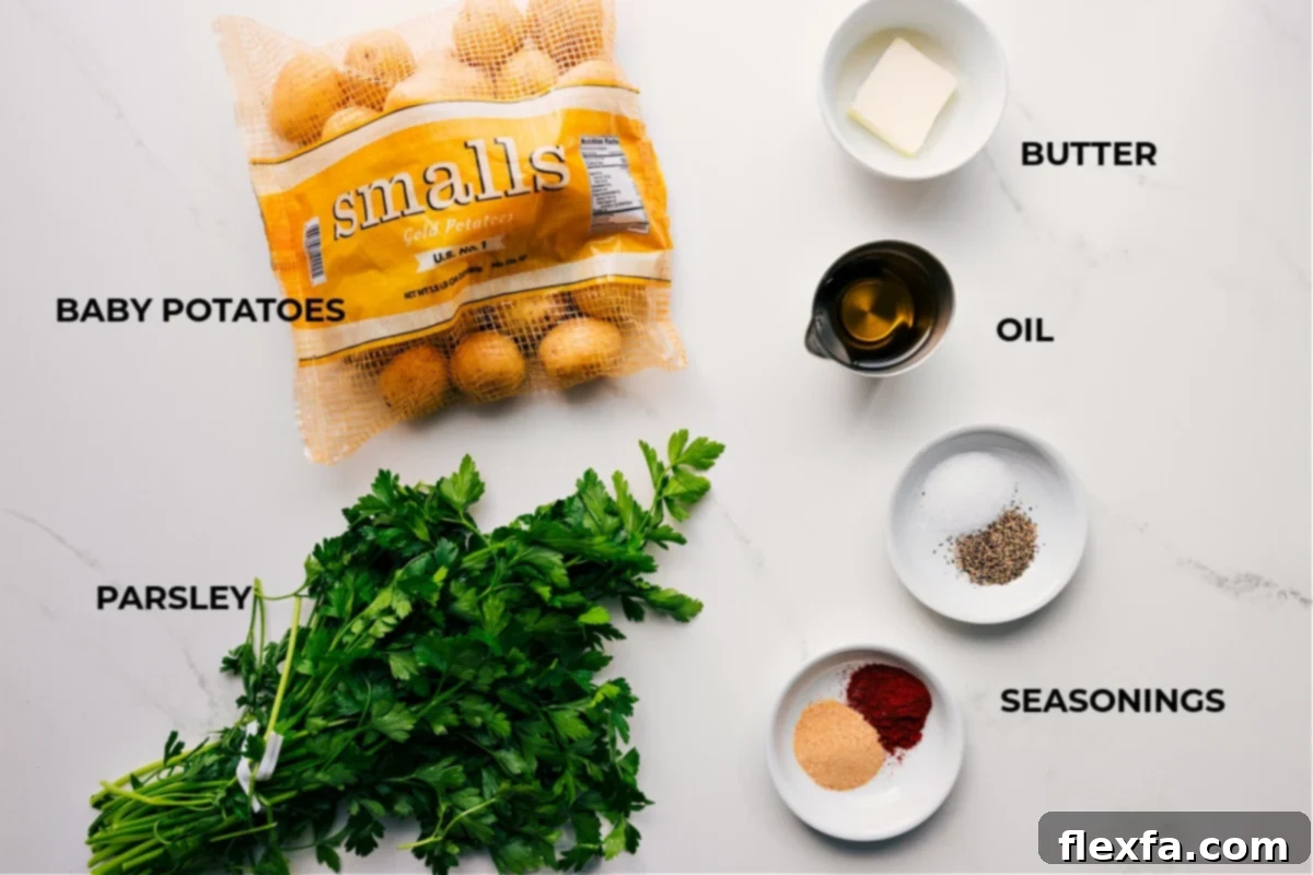 All the essential ingredients for this crispy smashed potatoes recipe laid out: baby potatoes, fresh parsley, melted butter, olive oil, and a selection of seasonings.
