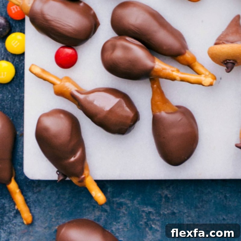 Fun and appealing candy turkey legs creatively made with pretzel sticks, soft caramel, and rich chocolate, perfect for a Thanksgiving party.