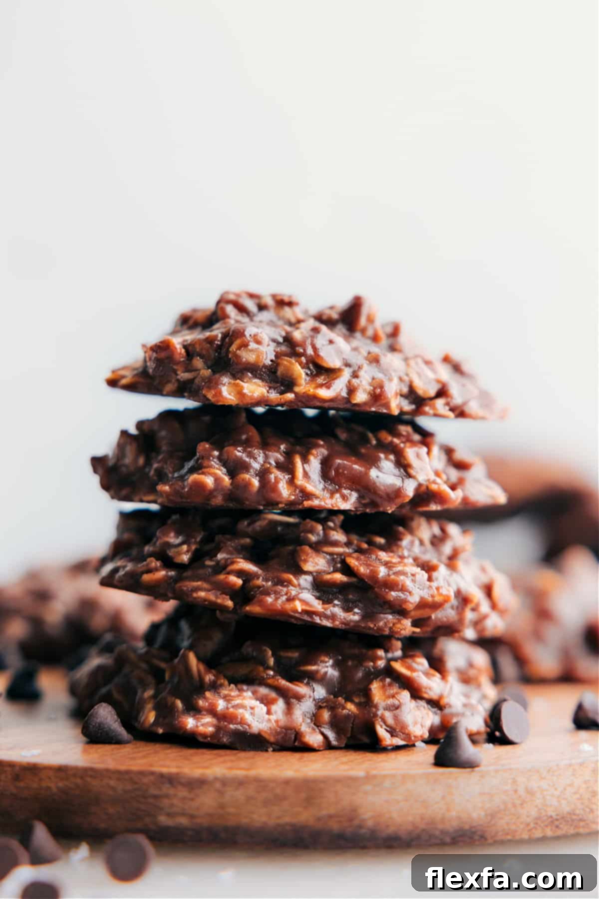 Stacked fudgy no bake cookies, perfectly set and ready to be enjoyed, highlighting their delicious texture.