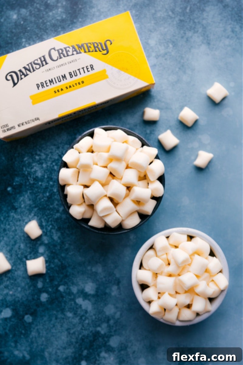 Two clear bowls filled with freshly made, soft Butter Mints, with a container of butter in the background, highlighting the key ingredient.