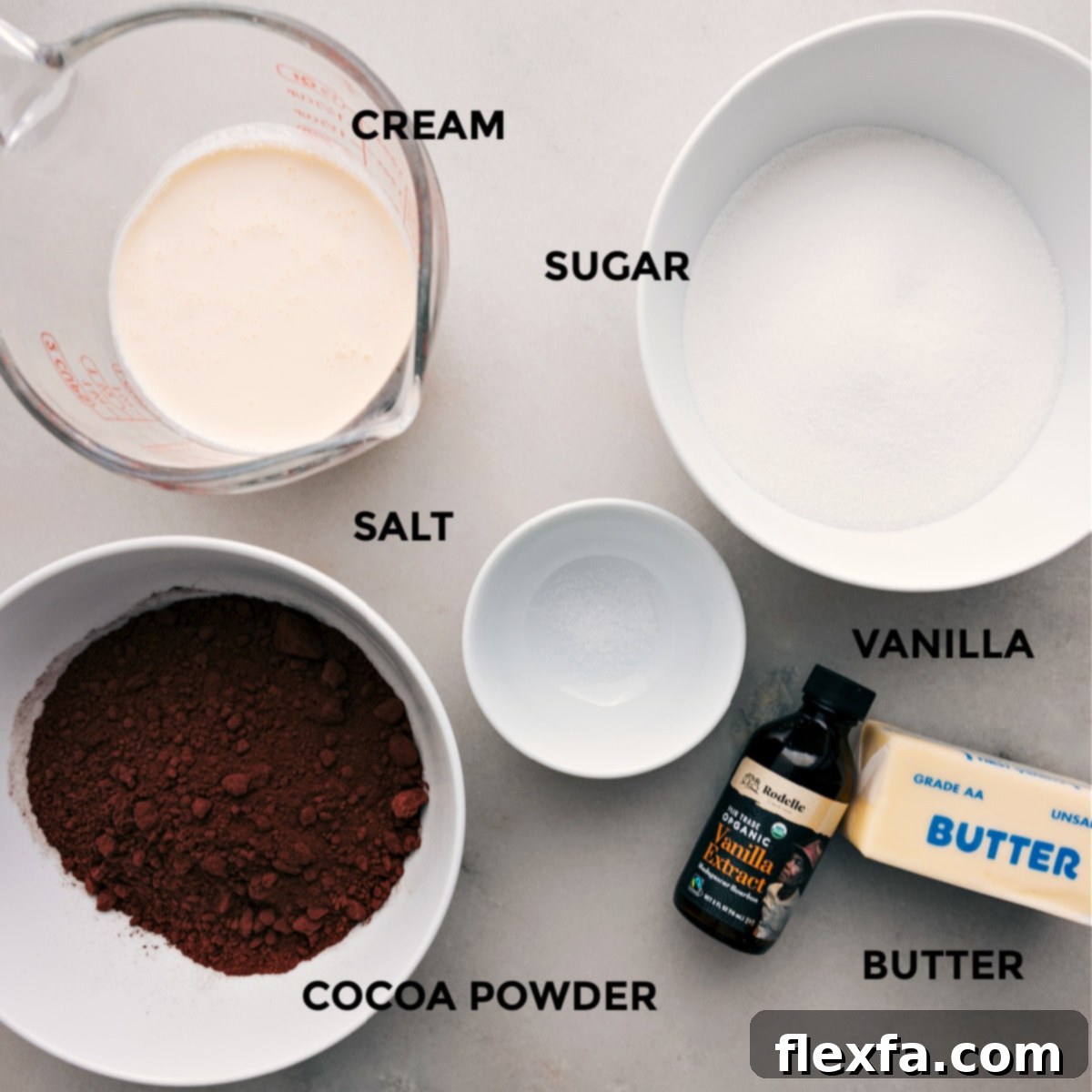 The essential ingredients for this homemade hot fudge recipe, including unsalted butter, granulated sugar, Dutch-process cocoa powder, heavy cream, vanilla extract, and salt, prepped for easy assembly.