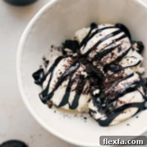 A delicious batch of homemade hot fudge sauce in a glass mason jar, ready for serving.