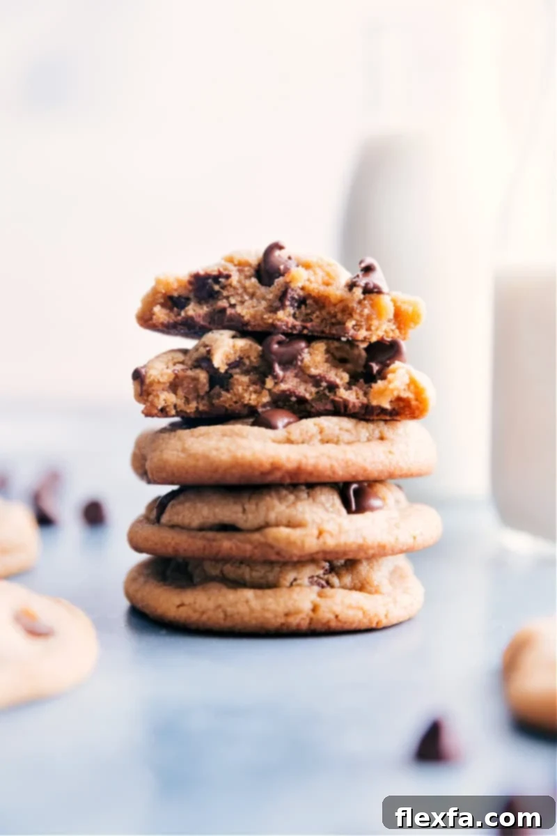 Irresistible Soft & Chewy Peanut Butter Chocolate Chip Cookies with a thick, luscious center and crisp edges. A must-try recipe for chocolate and peanut butter lovers! Image of the stacked Peanut Butter Chocolate Chip Cookies with a luxurious, soft appearance