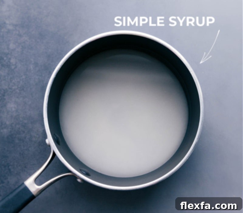 A pot on a stovetop with simple syrup being made, showing the clear liquid.