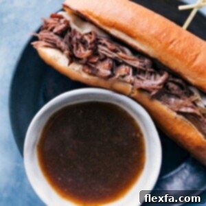 Hero shot of French Dip Sandwich with au jus for dipping.