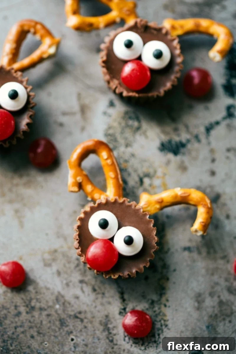 Christmas Reindeer Delights 2 Close-up of a finished mini reindeer treat made from a Reese's Cup, pretzels, candy eyeballs, and a red M&M nose.