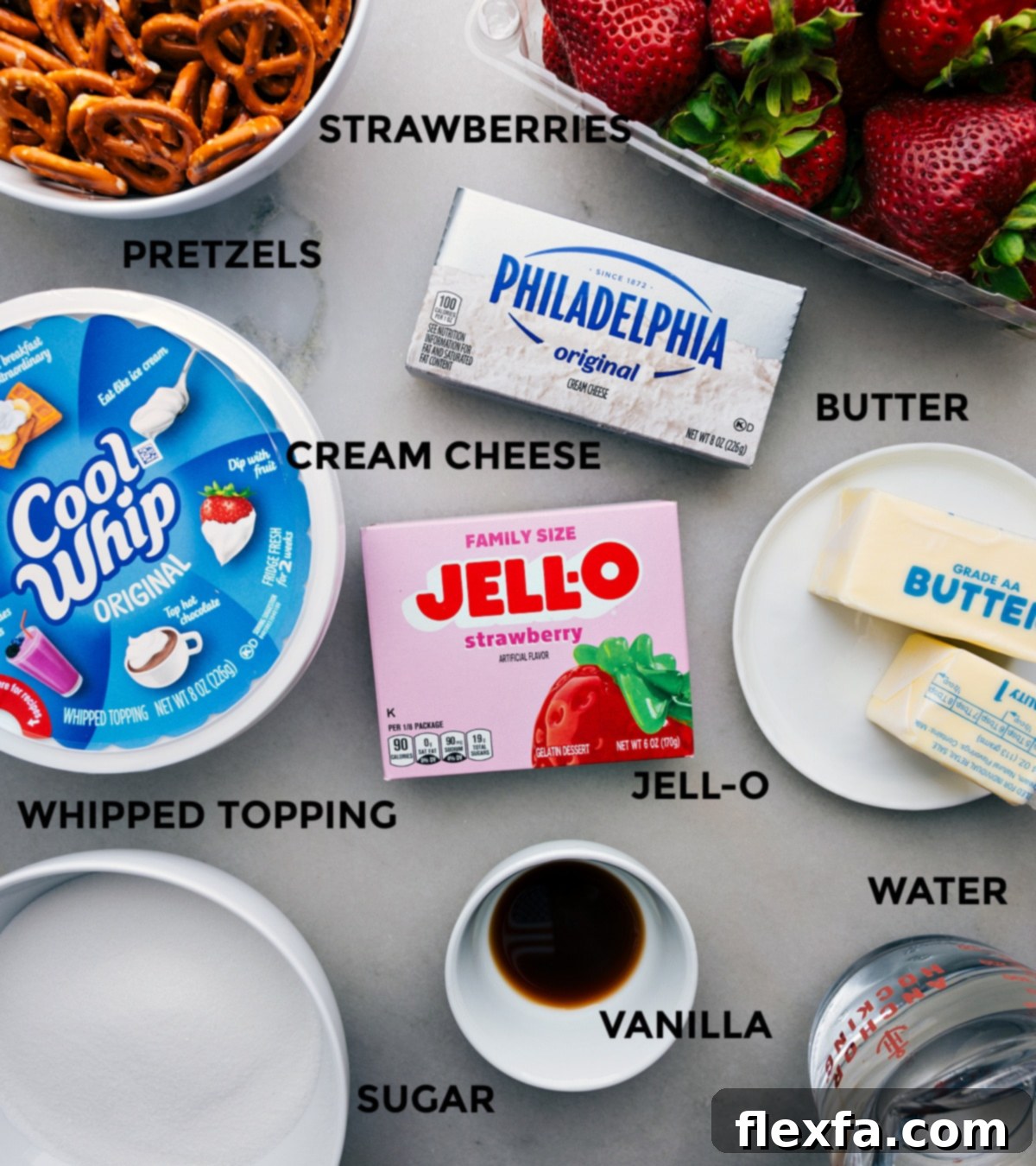 All the fresh ingredients for Strawberry Pretzel Salad prepped and laid out on a counter, ready for assembly.