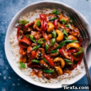 A close-up of the finished Cashew Chicken, rich and saucy, garnished with fresh herbs, ready to be enjoyed.