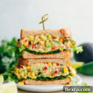 Mexican Street Corn Chicken Salad sandwiched between bread and lettuce.