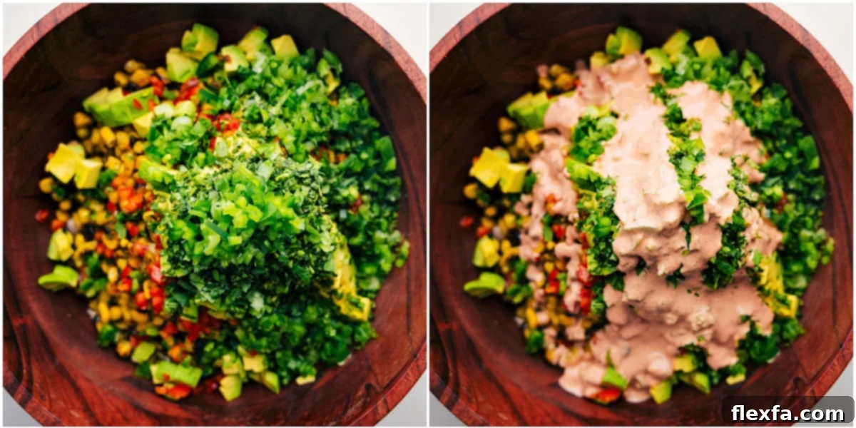 Combining all the ingredients and dressing in one large bowl for this Mexican Street Corn Chicken Salad recipe.