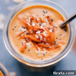 A vibrant Carrot Smoothie in a glass, ready to drink