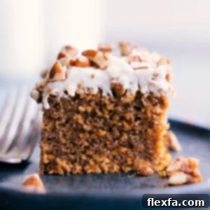 A perfectly portioned square of Gluten-Free Carrot Cake with frosting.